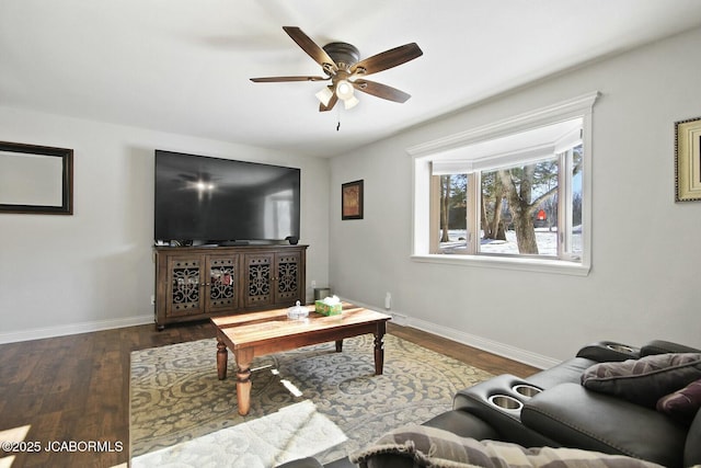 living room with ceiling fan and dark wood-type flooring