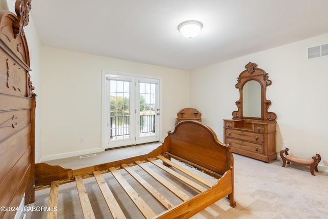 bedroom with light colored carpet and access to outside