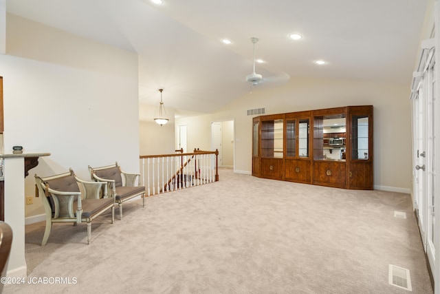 sitting room with light carpet, ceiling fan, and lofted ceiling