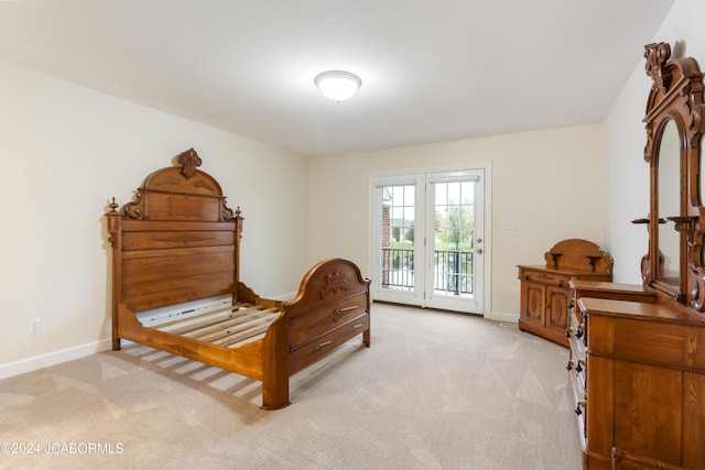 bedroom with access to exterior and light colored carpet