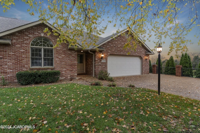 view of front facade featuring a yard and a garage