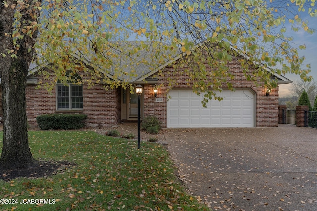 view of front facade with a garage and a front lawn