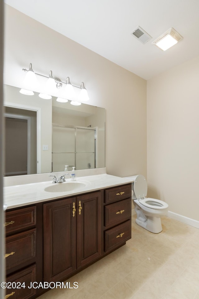 bathroom with toilet, vanity, and walk in shower