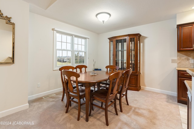 dining area with light colored carpet