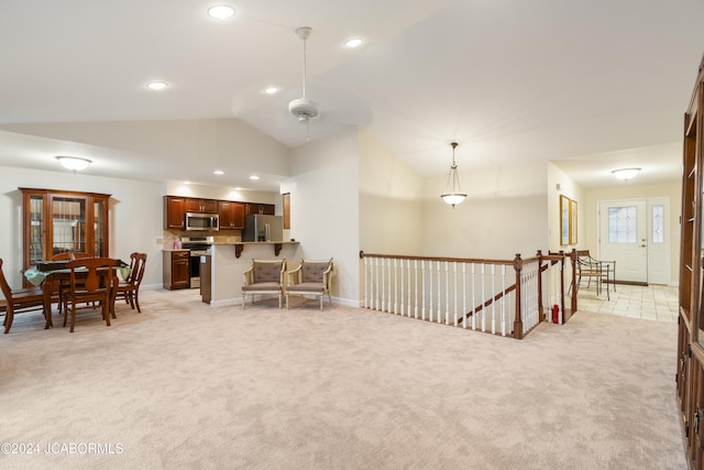 sitting room with light carpet, ceiling fan, and lofted ceiling