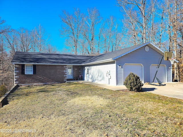 single story home featuring an attached garage, brick siding, driveway, and a front yard