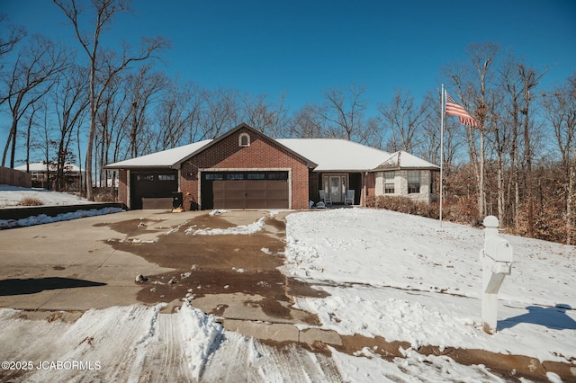 ranch-style home featuring a garage and brick siding