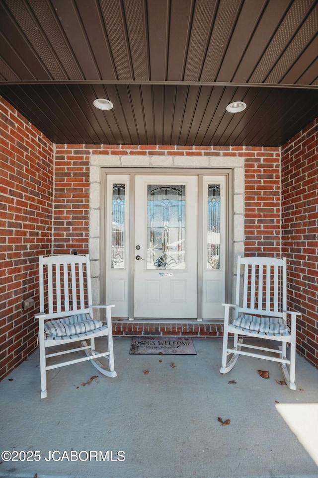 view of exterior entry with brick siding