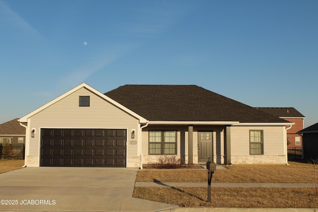 view of front of home featuring concrete driveway, an attached garage, and fence