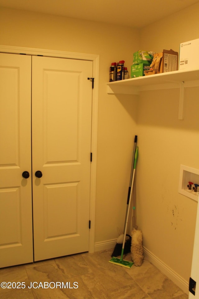 laundry area featuring laundry area, hookup for a washing machine, and baseboards