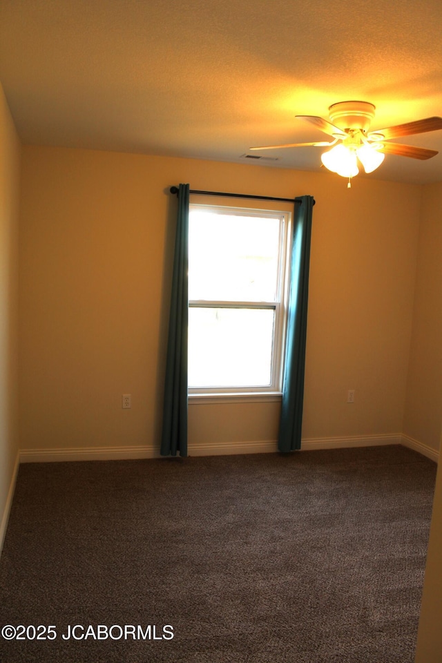 unfurnished room featuring carpet, baseboards, and ceiling fan