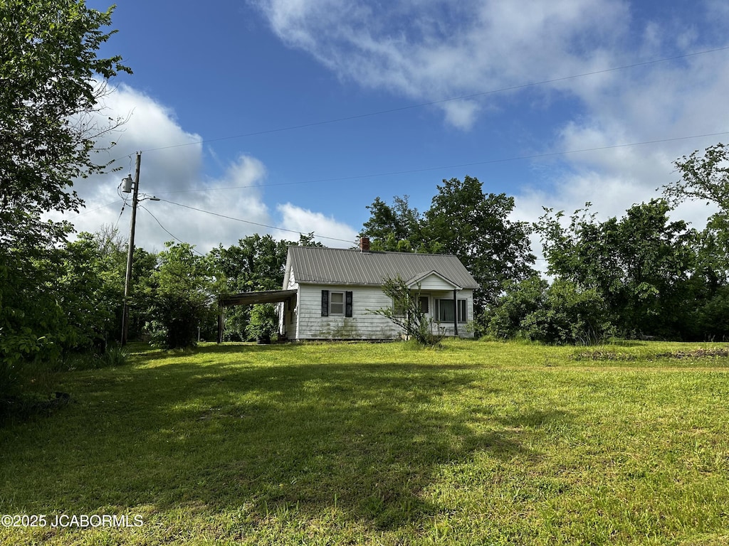 6908 Knernschield Rd, Russellville, MO 65074 - view of grassy yard featuring an attached carport