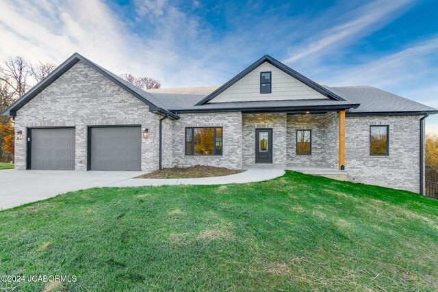 view of front of property with a front yard and a garage