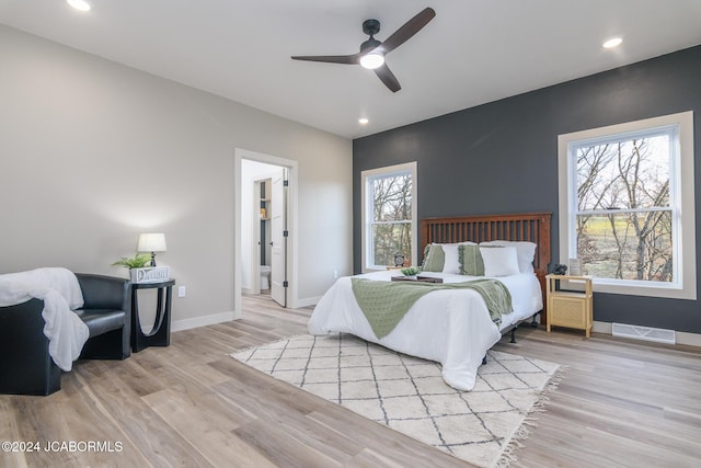 bedroom with light hardwood / wood-style floors and ceiling fan