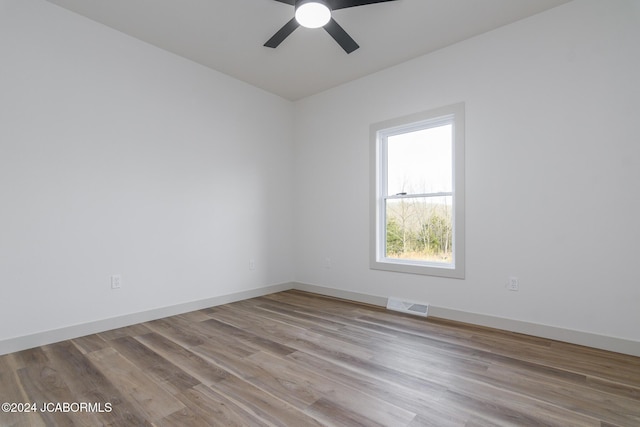 unfurnished room with ceiling fan and light hardwood / wood-style floors