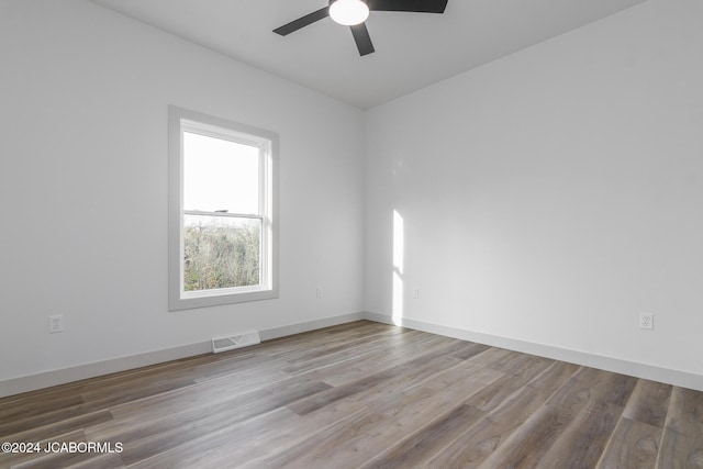 empty room with ceiling fan and wood-type flooring