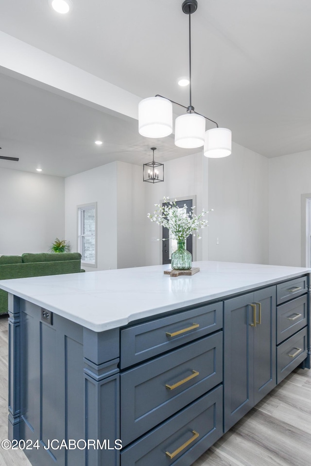 kitchen featuring an inviting chandelier, hanging light fixtures, and light wood-type flooring