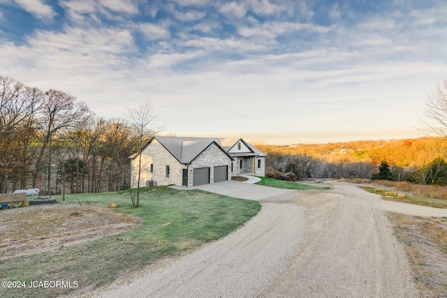 view of front of property with a garage and a yard