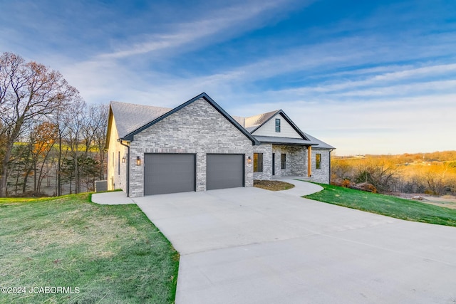 view of front of home featuring a front yard and a garage