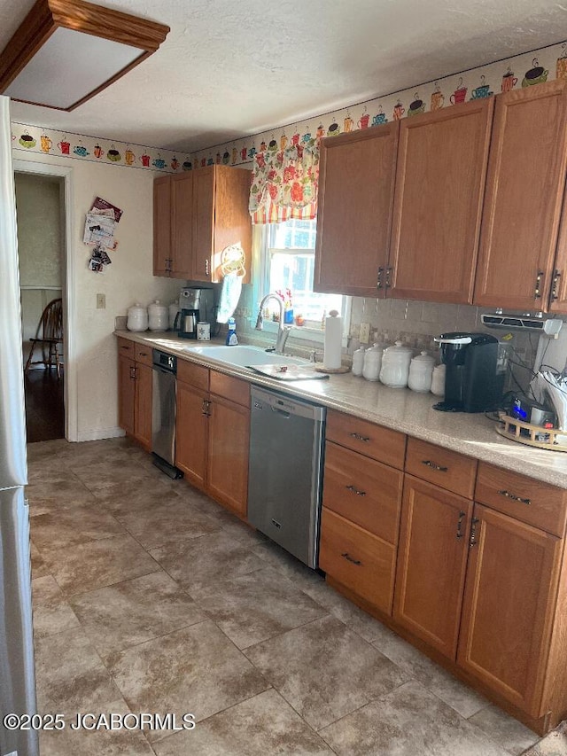 200 Sondra Ave, Columbia, MO 65202 - kitchen with a sink, brown cabinets, light countertops, and dishwasher