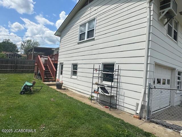 200 Sondra Ave, Columbia, MO 65202 - view of home's exterior with a yard, stairway, a wooden deck, and fence