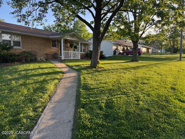 200 Sondra Ave, Columbia, MO 65202 - ranch-style house featuring a front lawn, brick siding, and a porch