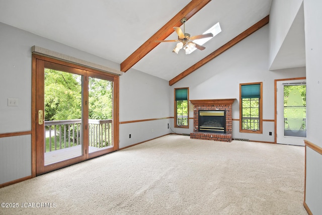 1101 E Maplewood Ct, Jefferson City, MO 65109 - unfurnished living room with beamed ceiling, carpet floors, a fireplace, high vaulted ceiling, and ceiling fan