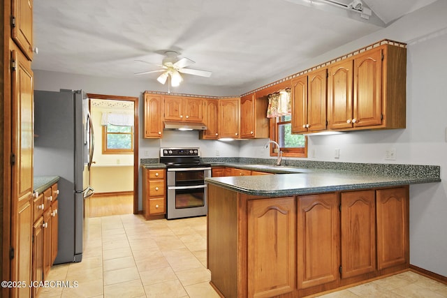 1101 E Maplewood Ct, Jefferson City, MO 65109 - kitchen with appliances with stainless steel finishes, a peninsula, a sink, brown cabinets, and a ceiling fan