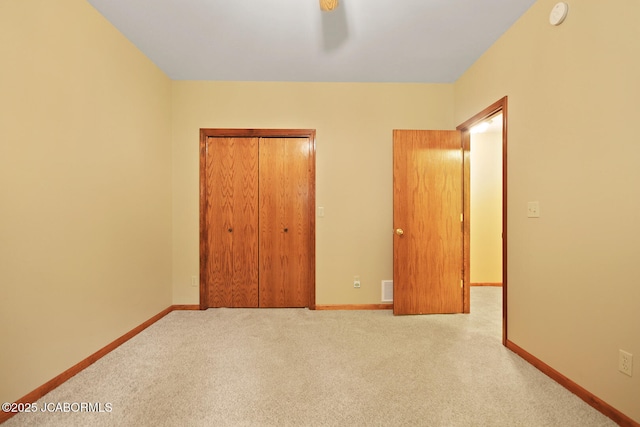 1101 E Maplewood Ct, Jefferson City, MO 65109 - unfurnished bedroom featuring carpet, a closet, baseboards, and ceiling fan