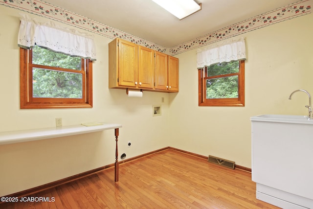 1101 E Maplewood Ct, Jefferson City, MO 65109 - laundry room with hookup for a washing machine, light wood-type flooring, cabinet space, and baseboards