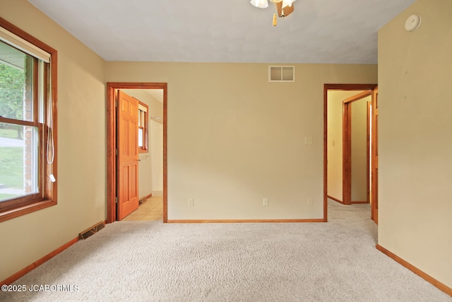 1101 E Maplewood Ct, Jefferson City, MO 65109 - empty room featuring light colored carpet, baseboards, and a smoke detector
