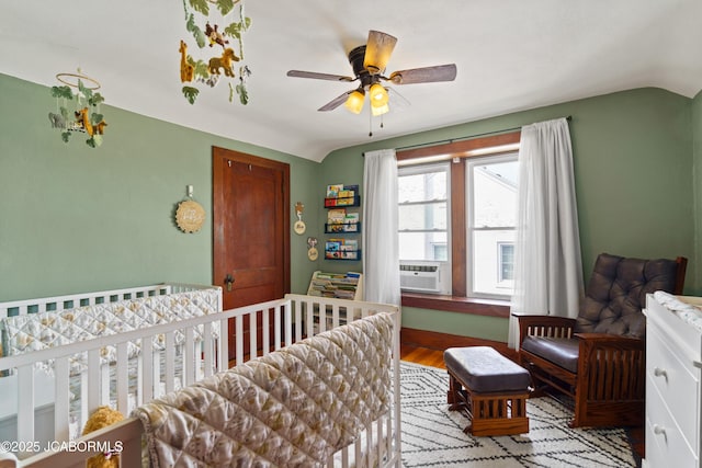 1400 W Main St, Jefferson City, MO 65101 - bedroom featuring lofted ceiling, wood finished floors, and a nursery area