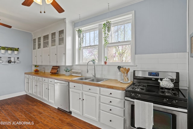 1400 W Main St, Jefferson City, MO 65101 - kitchen featuring appliances with stainless steel finishes, ceiling fan, crown molding, backsplash, and light countertops