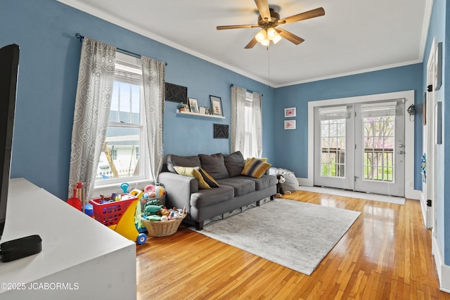 1400 W Main St, Jefferson City, MO 65101 - living room featuring healthy amount of natural light, wood finished floors, ceiling fan, and crown molding