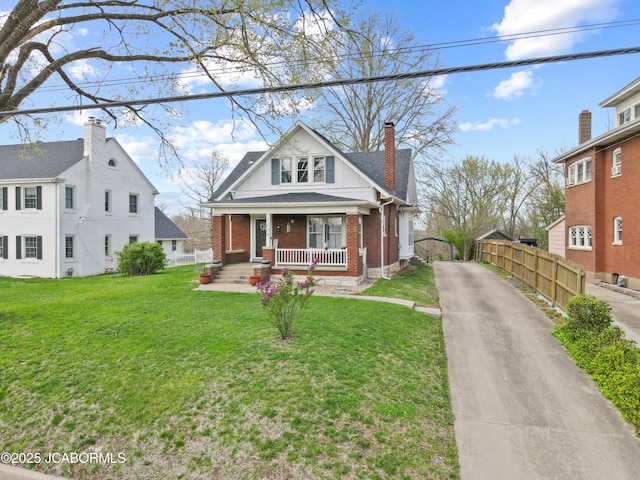 1400 W Main St, Jefferson City, MO 65101 - bungalow-style house with a porch, brick siding, a chimney, and driveway