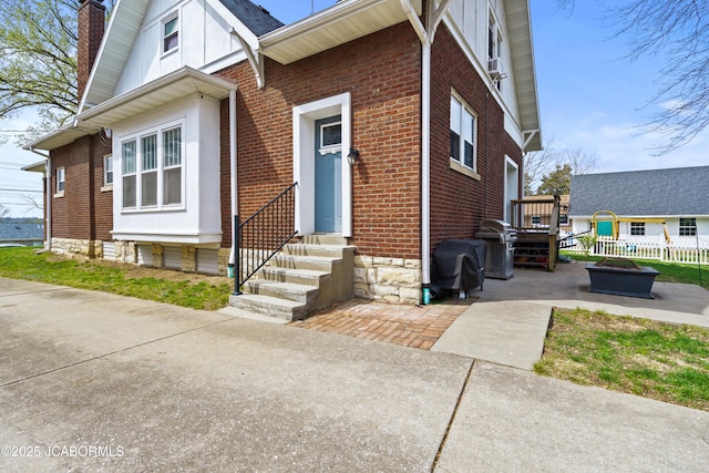 1400 W Main St, Jefferson City, MO 65101 - view of front of home featuring entry steps, brick siding, and a chimney