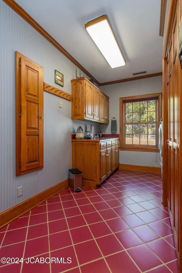 kitchen with crown molding and washer / dryer