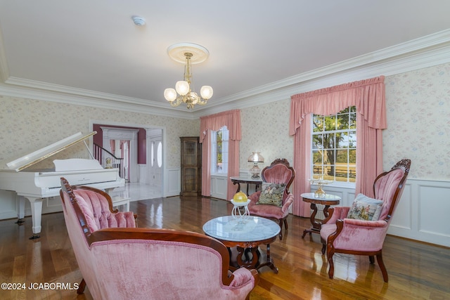 living area featuring dark hardwood / wood-style flooring, an inviting chandelier, and crown molding