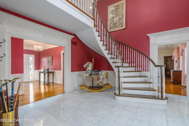 stairs with a notable chandelier