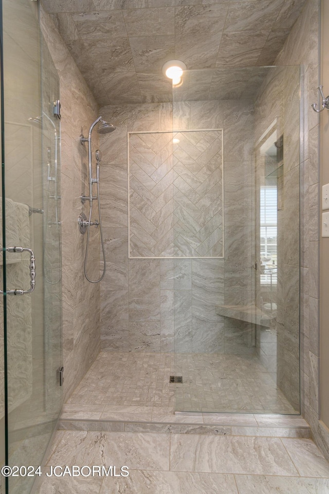 bathroom featuring a shower with door