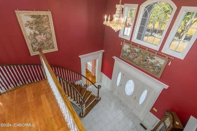 entrance foyer featuring light hardwood / wood-style flooring and a notable chandelier