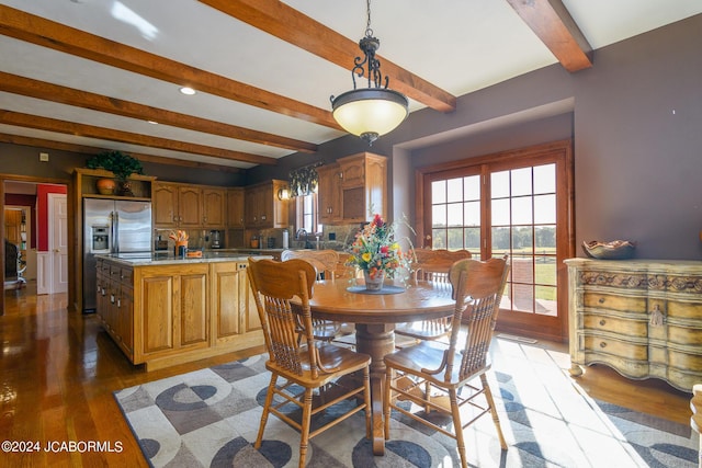 dining space with beamed ceiling and wood-type flooring