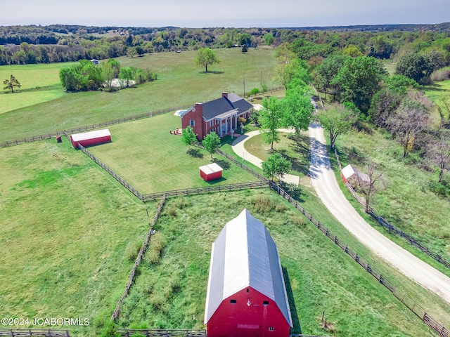 birds eye view of property with a rural view