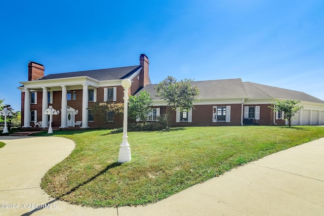 greek revival inspired property with a front lawn