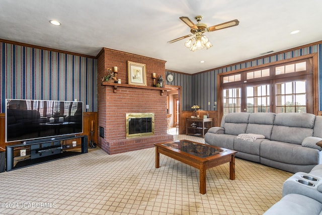 living room with light carpet, ceiling fan, ornamental molding, and a brick fireplace