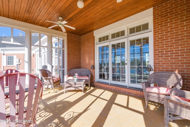 sunroom / solarium featuring ceiling fan and wooden ceiling