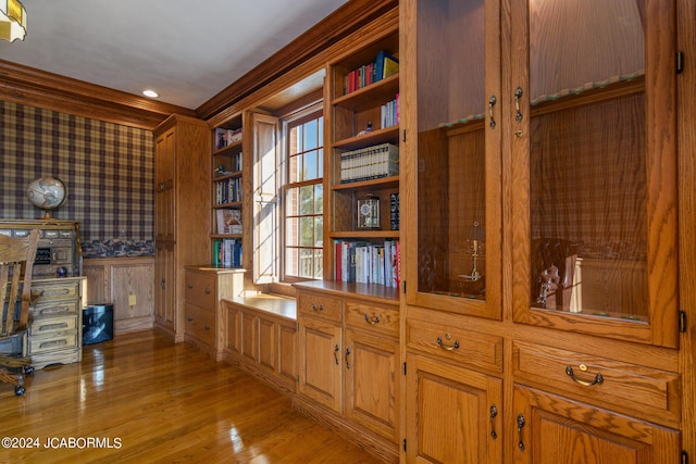 interior space with light hardwood / wood-style flooring and ornamental molding