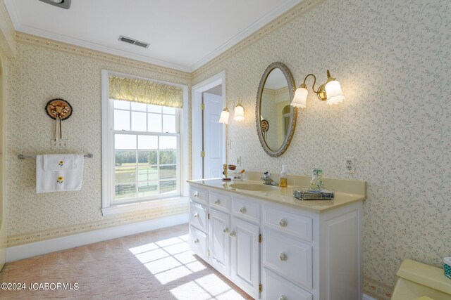 bathroom with crown molding, vanity, and toilet