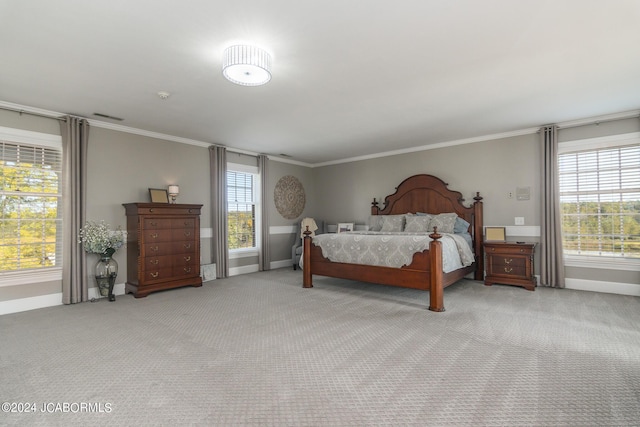 bedroom featuring light carpet, multiple windows, and ornamental molding