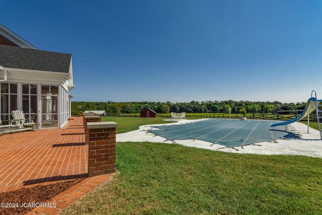 view of pool with a lawn